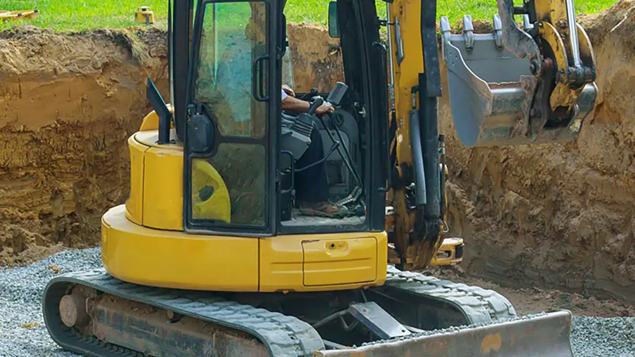 Digging and grading a foundation with excavator